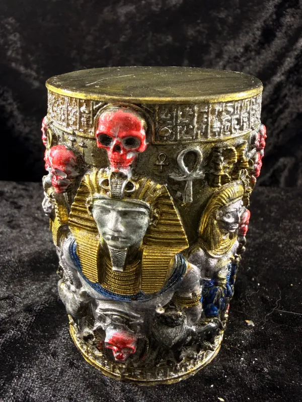 Egyptian-style candle pillar with skull motifs